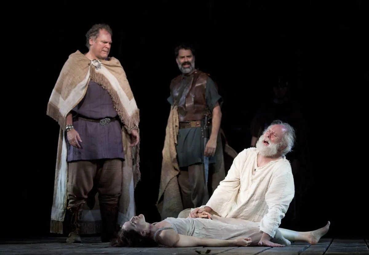(L–R) The Earl of Kent (Jay O. Sanders) and Duke of Albany (Christopher Innvar) watch as King Lear (John Lithgow) grieves for his beloved daughter Cordelia (Jessica Collins). (Joan Marcus)