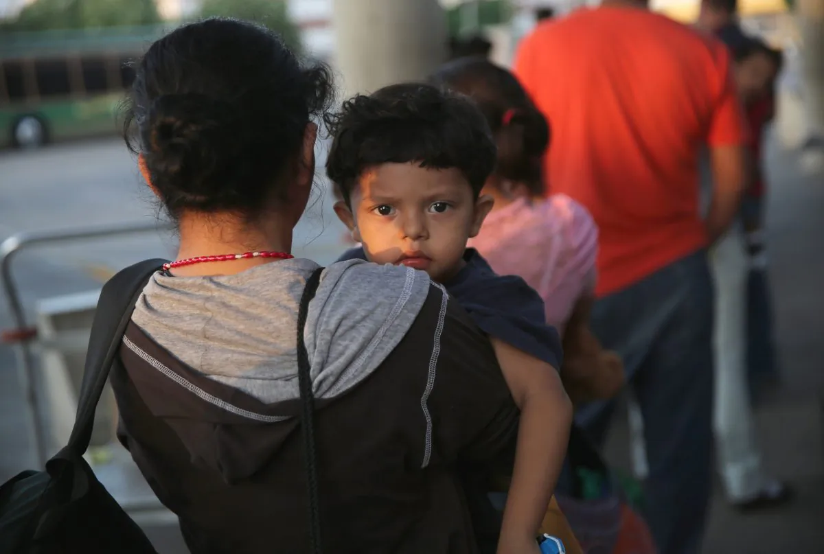 In this file photo,  Salvadorian immigrants just released from U.S. Border Patrol detention wait at the Greyhound bus station for their journey to Houston on July 25, 2014 in McAllen, Texas.  (Photo by John Moore/Getty Images)
