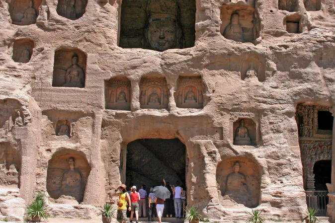 Tourist entering one of the caves in the Yungang Grottoes. (Greir/Shutterstock*) Yungang Grottoes are one of the most spectacular highlights of buddhist art in China.