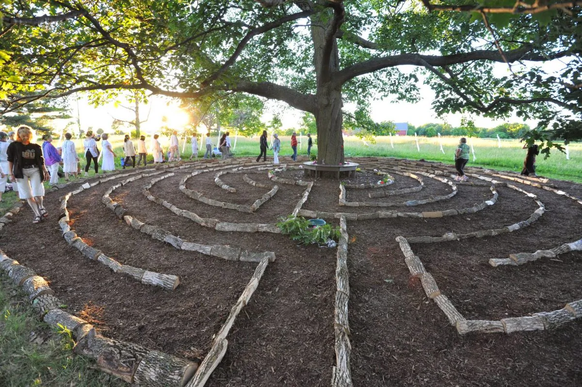 People walk through "Red Oak Labyrinth," Barbara Brown's installation at Beyond the Edge: Artists' Gardens. (Barbara Brown)
