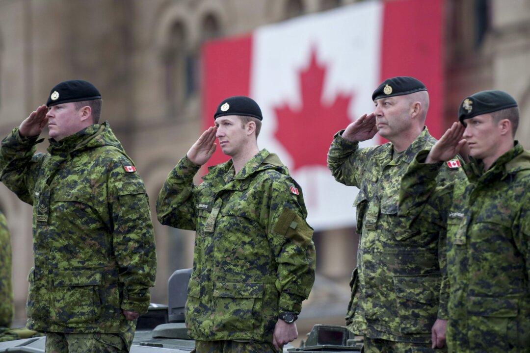 Canadian Forces members salute during the National Day of Honour on Parliament Hill on May 9, 2014. A new Statistics Canada study has found that mental health issues among members of the Canadian Forces have risen substantially in the past 12 years. (The Canadian Press/Justin Tang)
