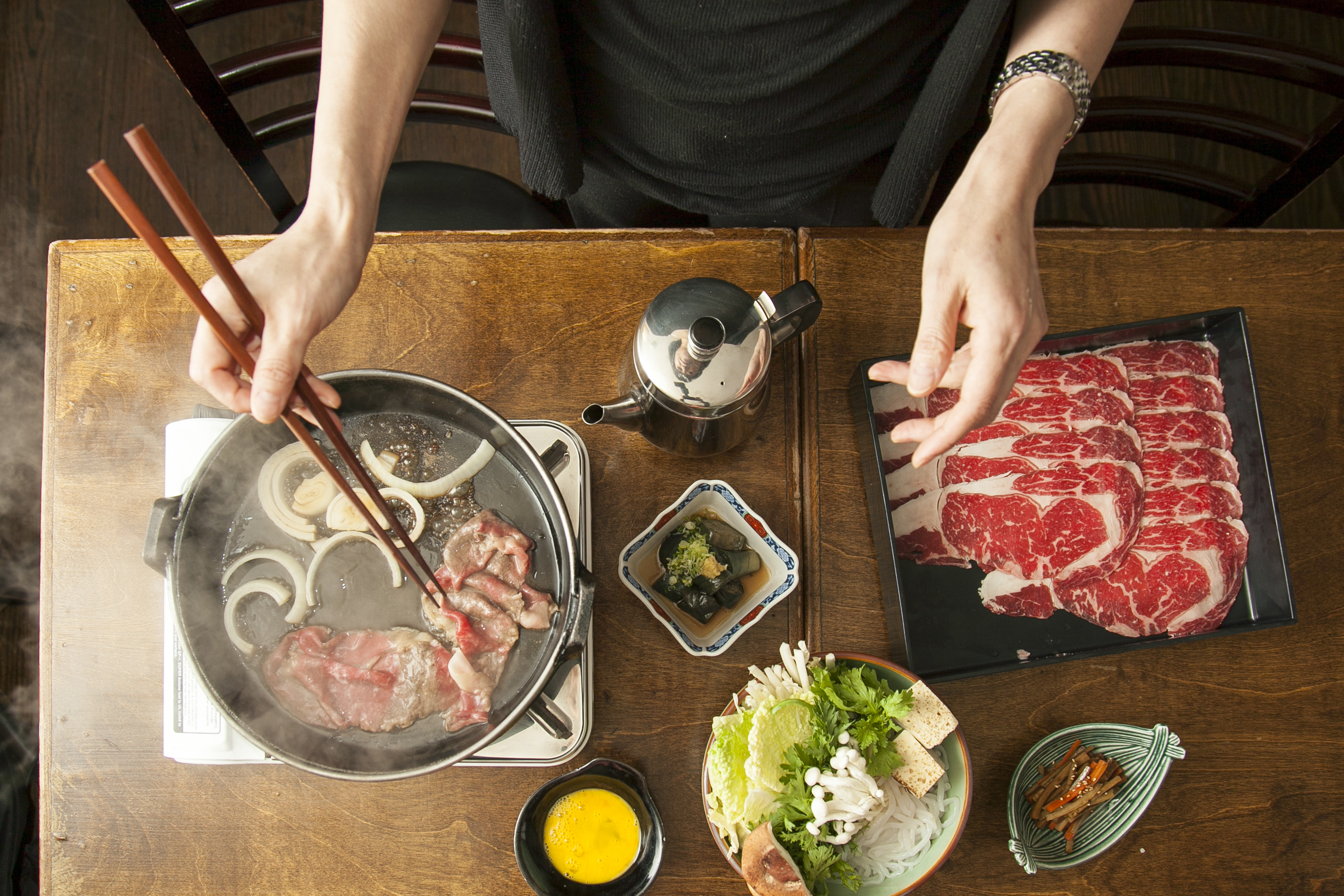 Momokawa owner and chef Mie Okuda cooking sukiyaki.