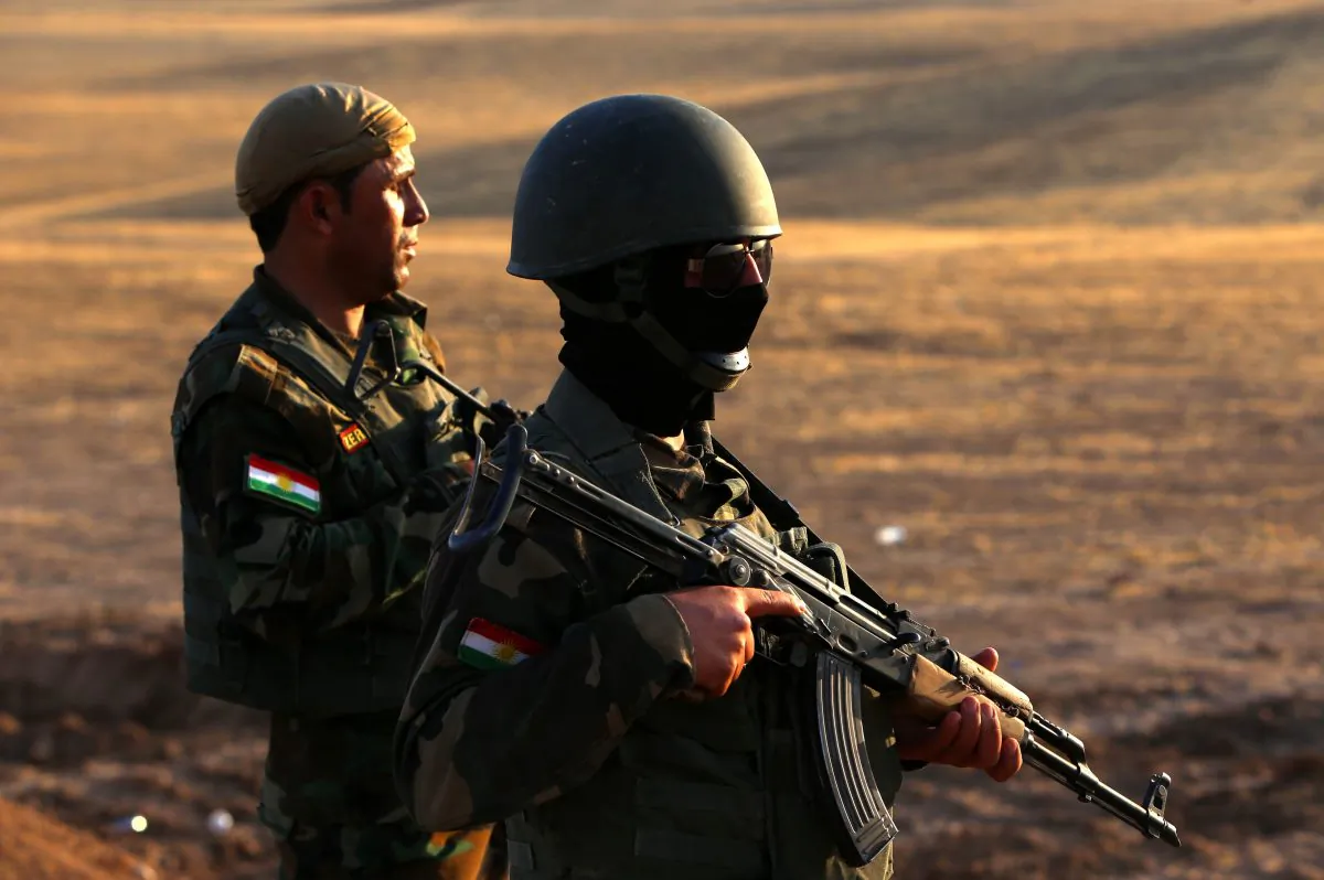 Iraqi Kurdish Peshmerga fighters take position on the front line in Khazer, near the Kurdish checkpoint of Aski kalak near the capital of the autonomous Kurdish region of northern Iraq, on August 14, 2014. (Safin Hamed/AFP/Getty Images)