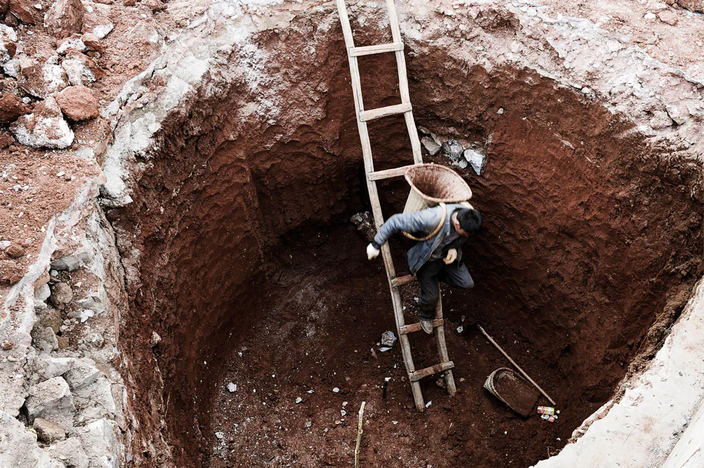 A Chinese farmer makes his way into a dried-up well in Fuyuan, Yunnan Province on Feb. 20, 2012. (STR/AFP/Getty Images)