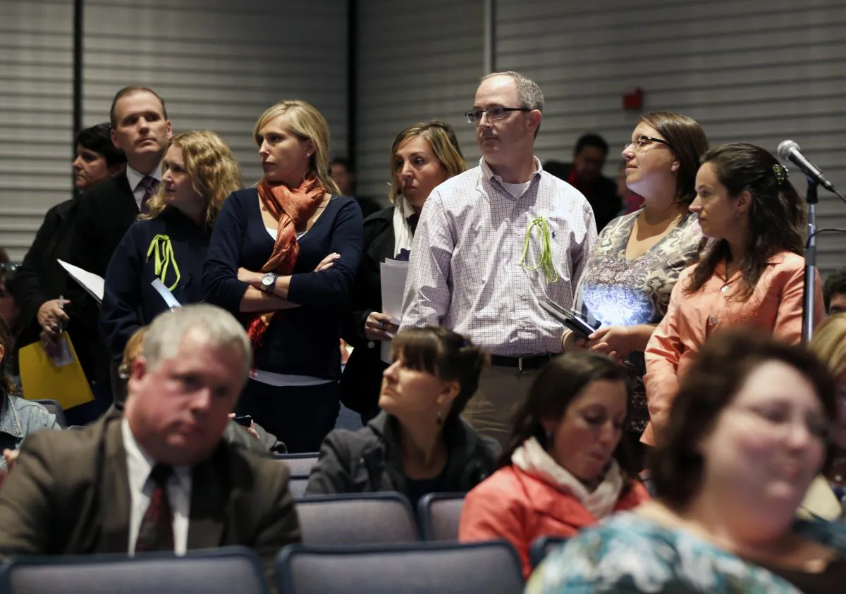 In this Oct. 24, 2013 file photo, people line up to speak at a Common Core learning reforms forum at the Stephen and Harriet Myers Middle School, in Albany, N.Y., on Oct. 24, 2013. Recent data shows many schools continue to struggle with the new tests, which were aligned to the Common Core standards for the second year. (AP Photo/Mike Groll, File)