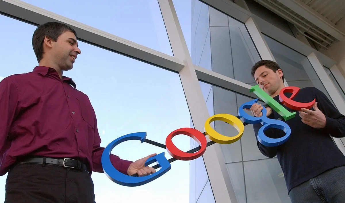 In thie file photo, Google co-founders Larry Page, left, and Sergey Brin pose for photos at their company's headquarters The search giant reported 2014 earnings with a $66 billion revenue in total, of which $18.1 billion was profit or income before taxes. (Ben Margot/AP Photo, File)