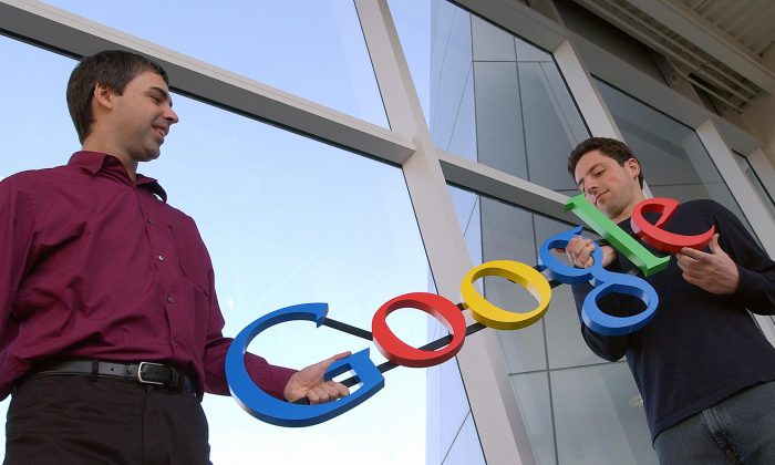 In thie file photo, Google co-founders Larry Page, left, and Sergey Brin pose for photos at their company's headquarters   The search giant reported 2014 earnings with a $66 billion revenue in total, of which $18.1 billion was profit or income before taxes. (Ben Margot/AP Photo, File)