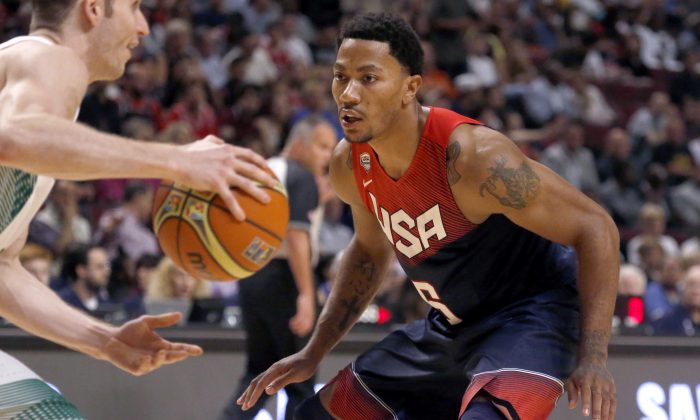 United States' Derrick Rose (6), of the Chicago Bulls defends against Brazil's Marcelo Huertas, during an exhibition game between the US and Brazilian national teams Saturday, Aug. 16, 2014, in Chicago. (AP Photo/Charles Rex Arbogast)