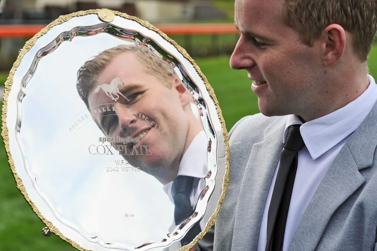 Jockey Tommy Berry poses with The Cox Plate trophy at Moonee Valley Racecourse in Melbourne, Australia, on Aug. 5, 2014. (Vince Caligiuri/Getty Images)