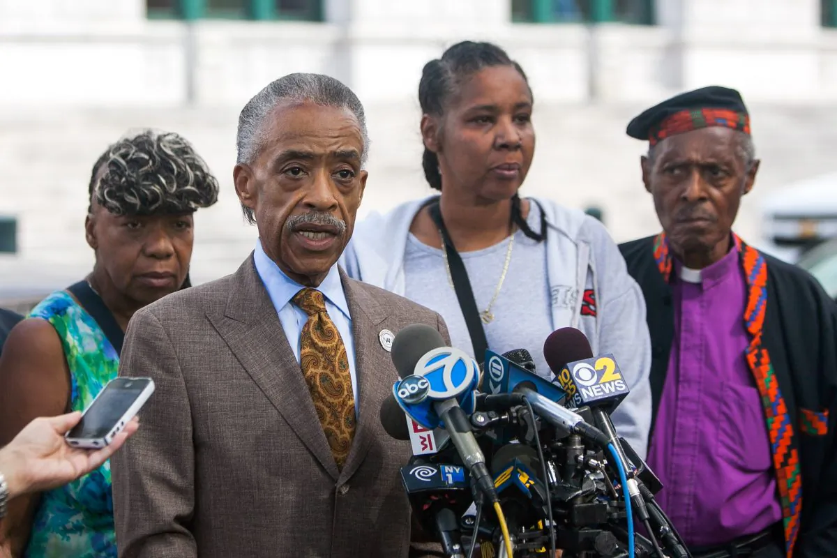Rev. Al Sharpton speaks at a press conference in Brooklyn, Aug. 21, 2014, with Esaw Garner (2nd R), wife of Eric Garner killed during a police arrest. (Petr Svab/Epoch Times)