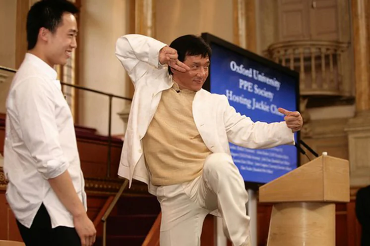 Jackie Chan strikes a Kung Fu pose on stage with Bo Guagua, son of disgraced former communist official Bo Xilai, at Oxford University in 2008. (Screenshot/takungpao.com)