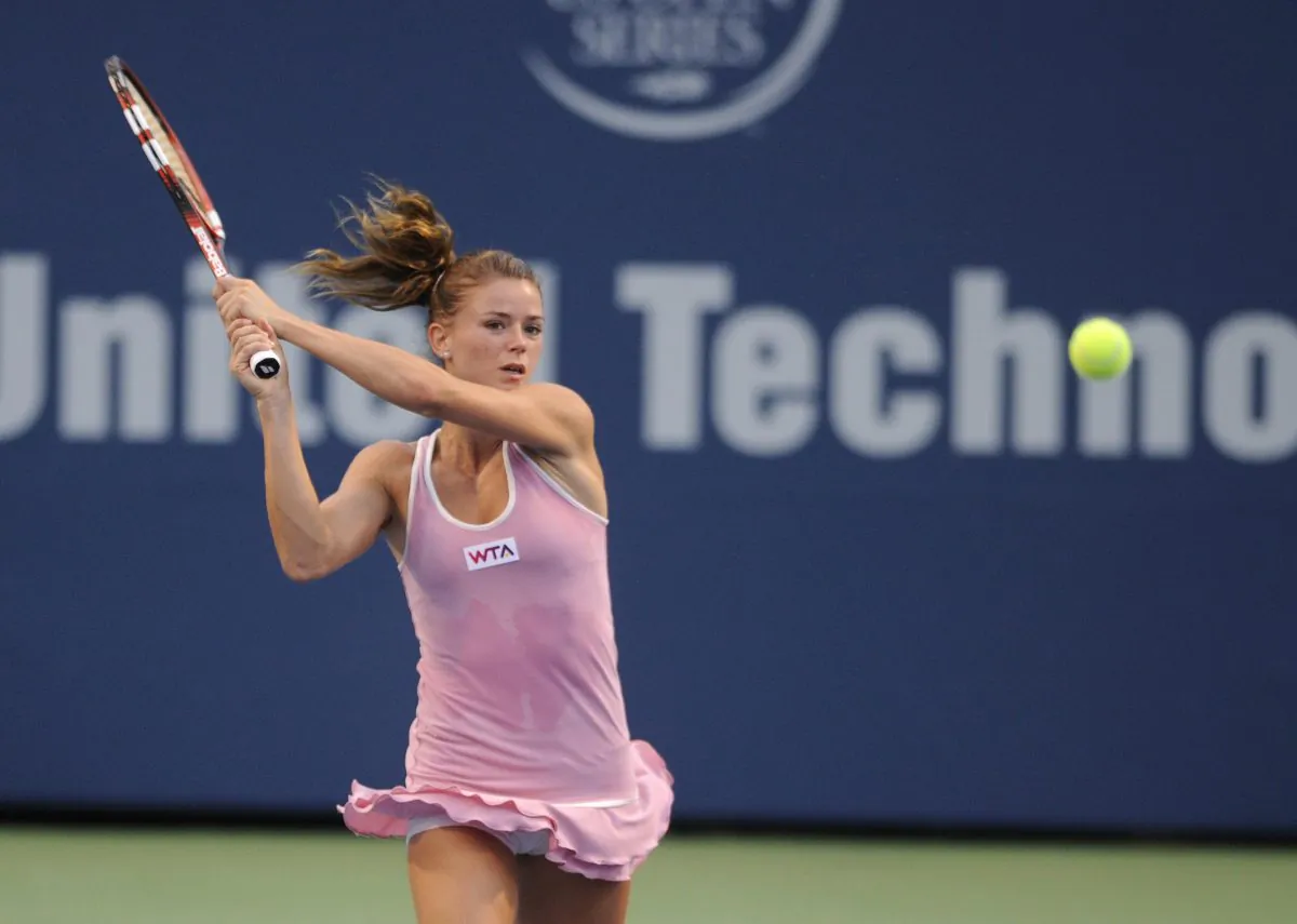 Camila Giorgi, of Italy, watches a backhand during her 6-4, 6-7 (4), 6-2 victory over Garbine Muguruza, of Spain, in a quarterfinal match at the New Haven Open tennis tournament in New Haven, Conn., Thursday, Aug. 21, 2014. (AP Photo/Fred Beckham)