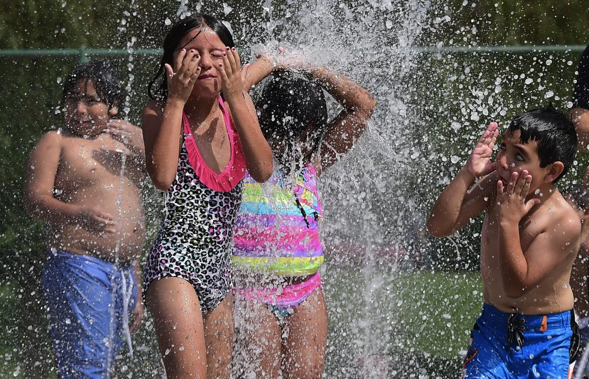 Children play in a fountain in this file photo. The U.S. Department of Agriculture released its annual report on the cost of raising a child. (FREDERIC J. BROWN/AFP/Getty Images)