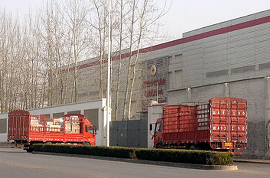 Large trucks loaded with supplies drive into the gate of a disaster preparedness warehouse belonging to the Chinese Red Cross in Beijing, on April 1, 2014. According to Tencent Financial, the Chinese Red Cross is renting the state-funded warehouse for profit to logistics companies. (Screenshot/Tencent Finance)