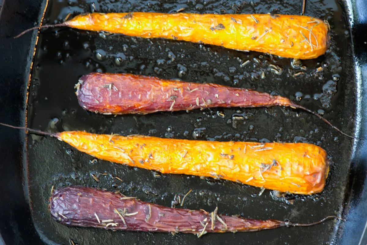 A half recipe of red and orange heirloom carrots roasted in a cast iron skillet with dried rosemary and sage. (Cat Rooney/Epoch Times)
