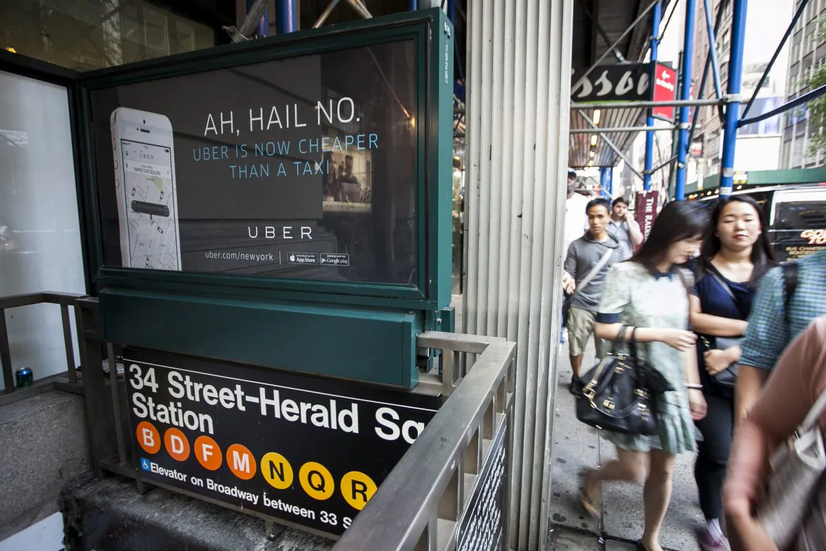 An Uber advertisement on top of the Herald Square subway entrance in Manhattan, New York City, on Aug. 20, 2014. (Samira Bouaou/Epoch Times)