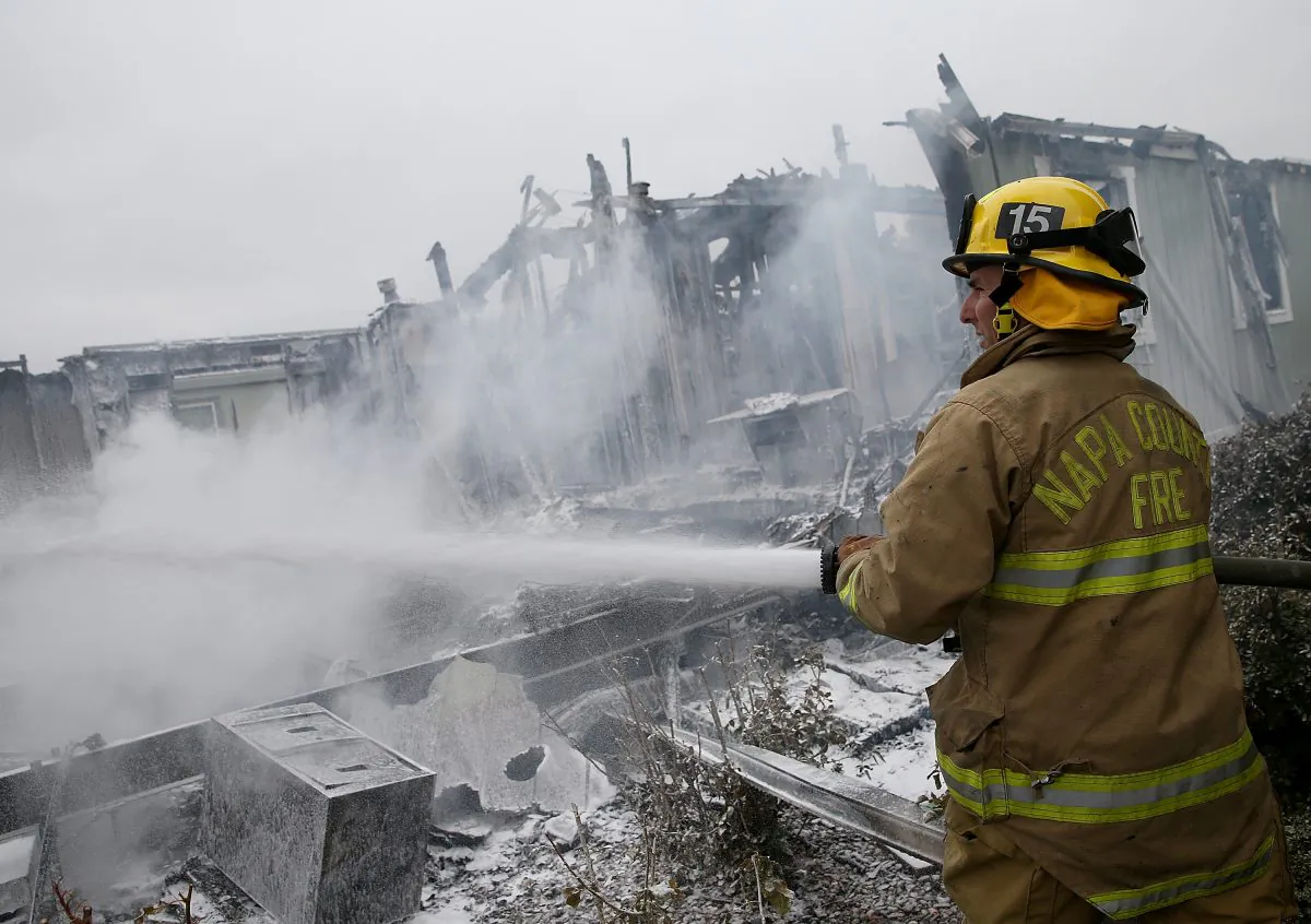 A Napa County firefighter sprays foam on hot spots from a fire at a mobile home park following a reported 6.1 earthquake on August 24, 2014 in Napa, California. (Justin Sullivan/Getty Images)
