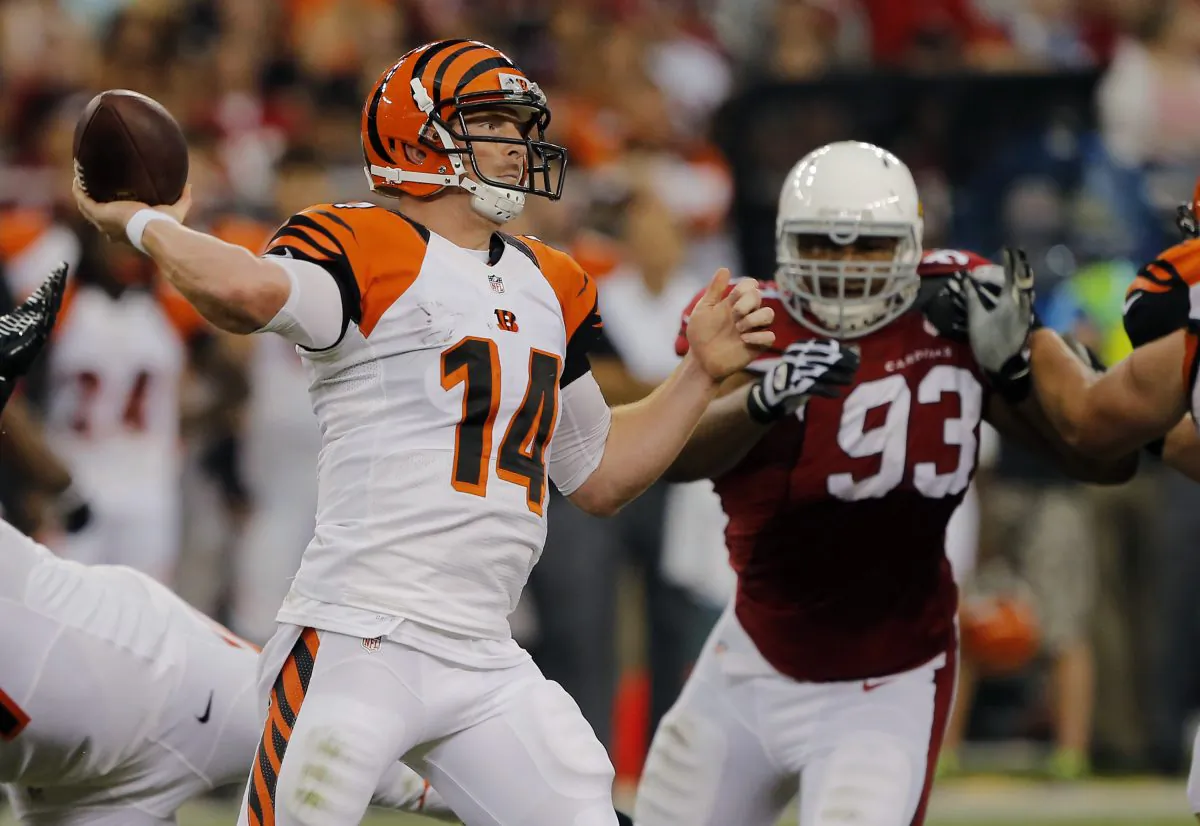 Cincinnati Bengals quarterback Andy Dalton (14) throws as Arizona Cardinals defensive end Calais Campbell (93) pursues during the first half of an NFL preseason football game in Glendale, Ariz., Aug. 24, 2014. (Rick Scuteri/AP Photo)