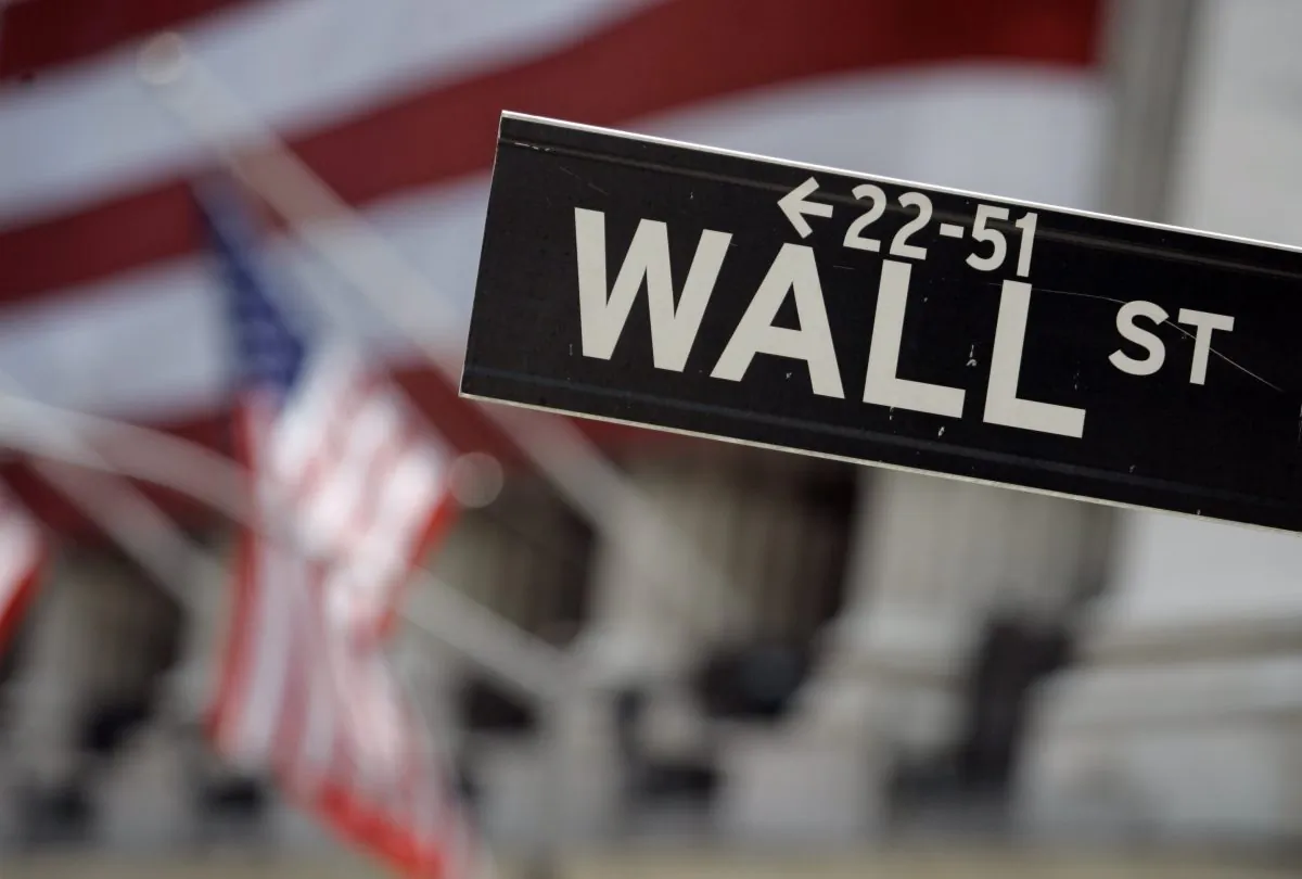 In this May 11, 2007, file photo, a Wall Street sign is mounted near the flag-draped facade of the New York Stock Exchange. (AP Photo/Richard Drew)