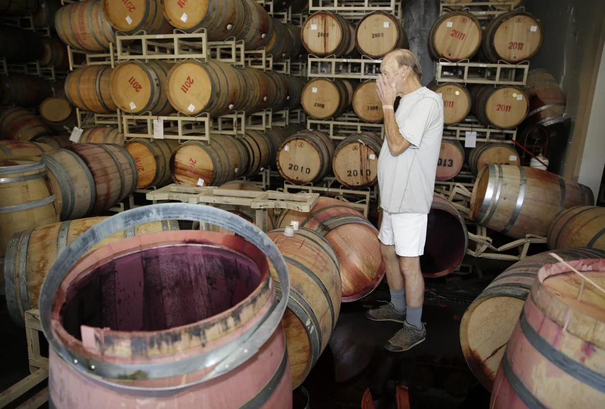 Winemaker Tom Montgomery stands in spilled wine at the B.R. Cohn Winery barrel storage facility in Napa, Calif., on Aug. 24, 2014, following an magnitude-6.0 earthquake struck the area. (AP Photo/Eric Risberg)