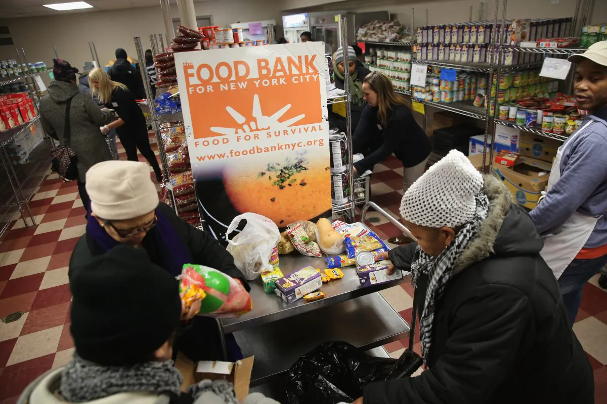 Harlem residents choose free groceries at the Food Bank For New York City on Dec. 11, 2013. (John Moore/Getty Images)