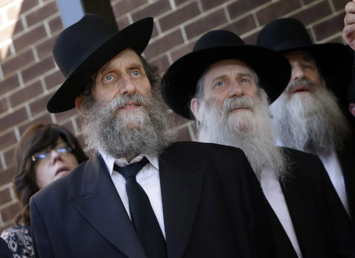 People listen during a news conference about the disappearance, in Israeli, of Aaron Sofer, 23, Tuesday, Aug. 26, 2014, in Lakewood, N.J. (AP Photo/Mel Evans)