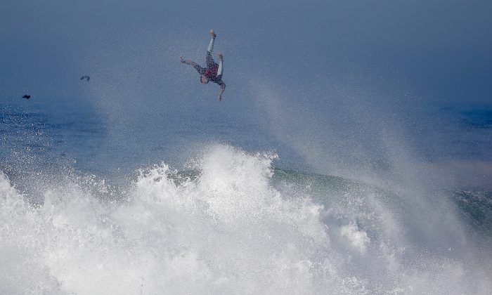 A surfer flies off a wave at the wedge in Newport Beach, Calif., Wednesday, Aug. 27, 2014. Southern California beachgoers experienced much higher than normal surf, brought on by Hurricane Marie spinning off the coast of Mexico. (AP Photo/Chris Carlson)