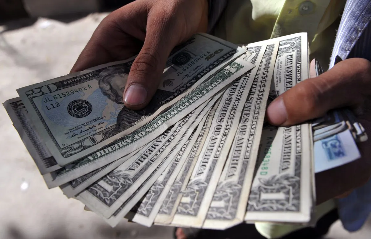 An Afghan moneychanger counts U.S. dollar notes on a street in Kabul on Oct. 1, 2011. (Adek Berry/AFP/GettyImages)