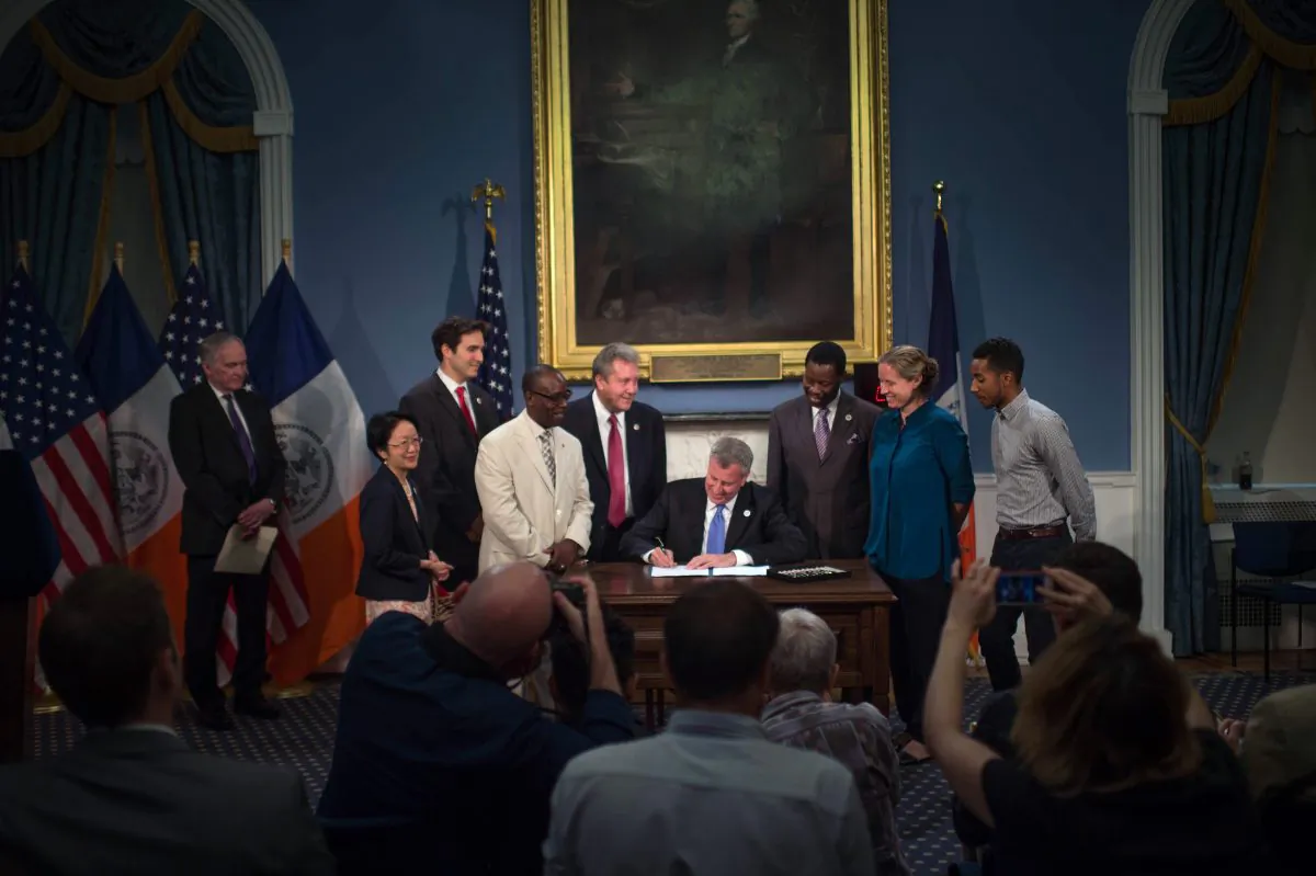 Mayor Bill de Blasio signs a series of bills into law, at the Blue Room in City Hall, New York, on Thursday, Aug. 28, 2014. (New York City Mayor's Office)