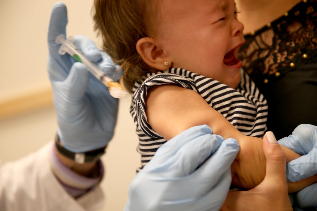In this file photo, a baby cries as a pediatrician administers a measles vaccination during a visit to the Miami Children's Hospital on June 02, 2014 in Miami, Florida. (Joe Raedle/Getty Images)