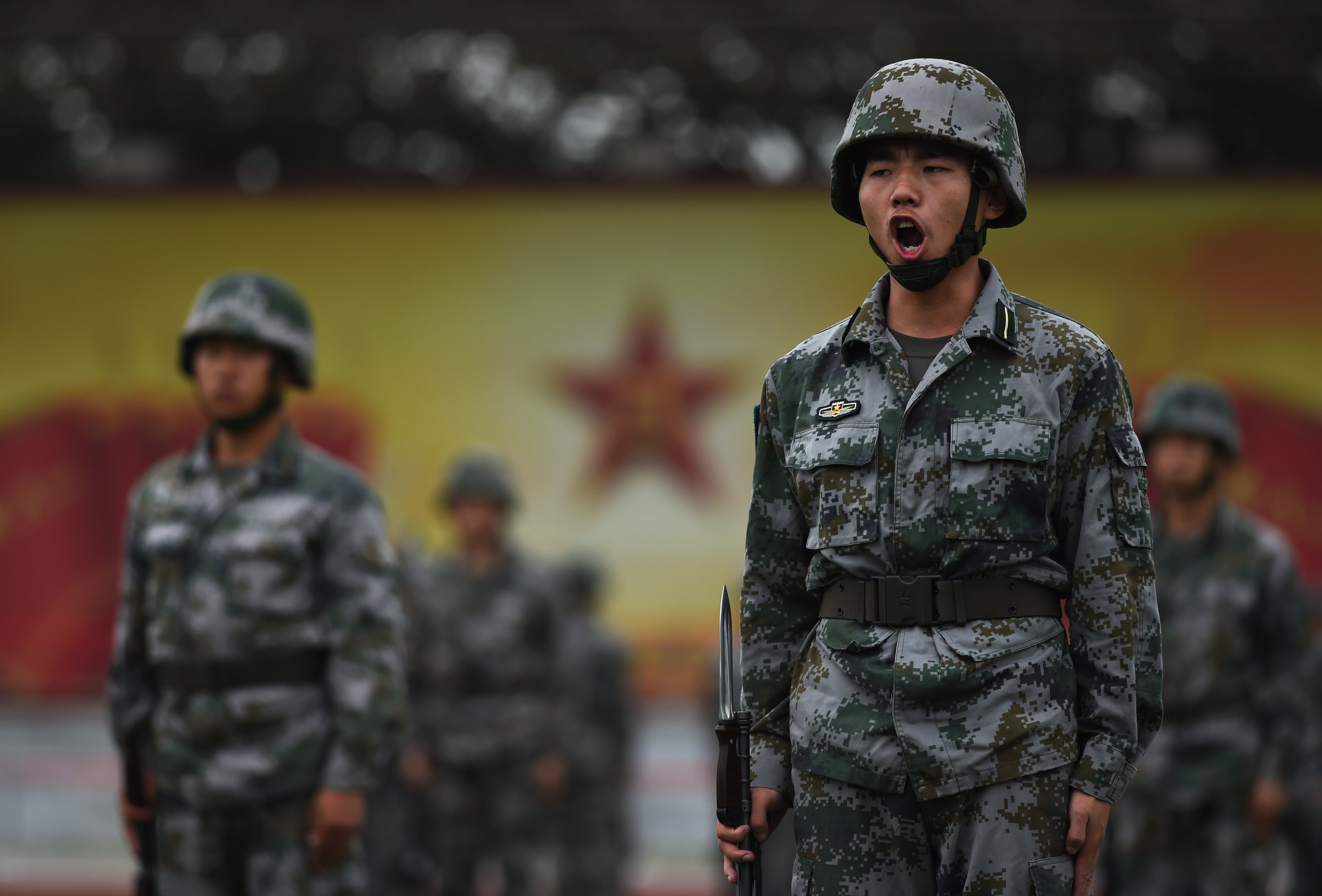 Chinese People's Liberation Army cadets train in Beijing on July 22. The Chinese military is setting new standards for studying Communist doctrine, at the expense of training. (Greg Baker/AFP/Getty Images)