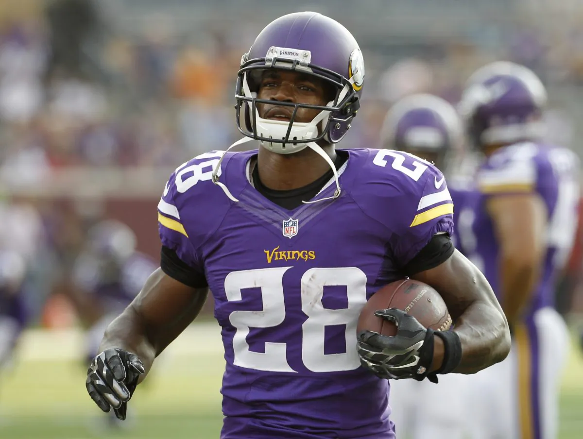 In this Aug. 16, 2014, photo, Minnesota Vikings running back Adrian Peterson (28) warms up before a NFL preseason football game against the Arizona Cardinals in Minneapolis.Millions of people using the top three fantasy football platforms have generated three different answers to the question of that top draft pick. Yahoo says LeSean McCoy of Philadelphia. ESPN says Adrian Peterson. CBS Sports says it’s Jamaal Charles of Kansas City. (AP Photo/Ann Heisenfelt)