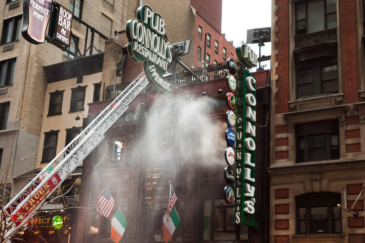 A fast spreading two-alarm fire broke out and destroyed a popular family owned and operated Irish pub, Connolly's Pub and Restaurant, on West 45th Street, Manhattan, Aug. 30, 2014. (Petr Svab/Epoch Times)