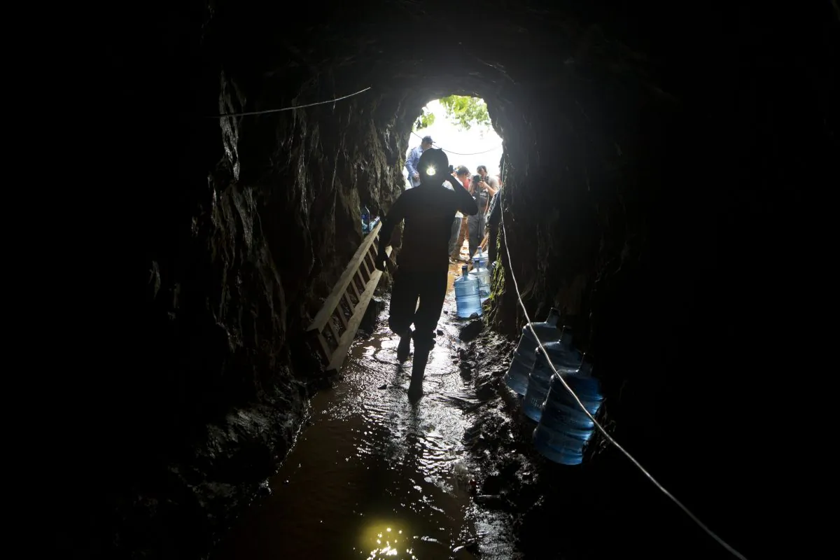 A miner enters the El Comal gold and silver mine to help with rescue operations after a landslide trapped at least 24 miners inside, in Bonanza, Nicaragua, on Aug. 29, 2014. (Esteban Felix/AP Photo)