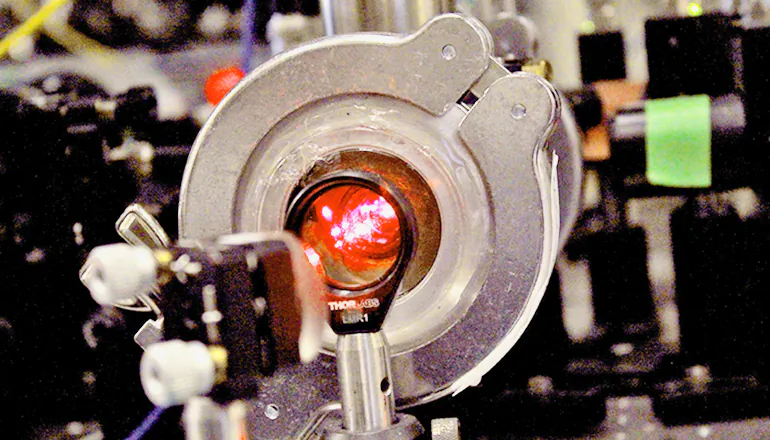 Scientists built their own apparatus in a basement lab. It is an elaborate tangle of wires, computers, electrical components, tabletop mirrors, and a cryogenic refrigeration unit. "If you wanted to put a picture of something high-tech in the dictionary, this is what it might look like," Dave DeMille says. "It's deeply orderly, but with a bit of chaos." (Michael Helfenbein)