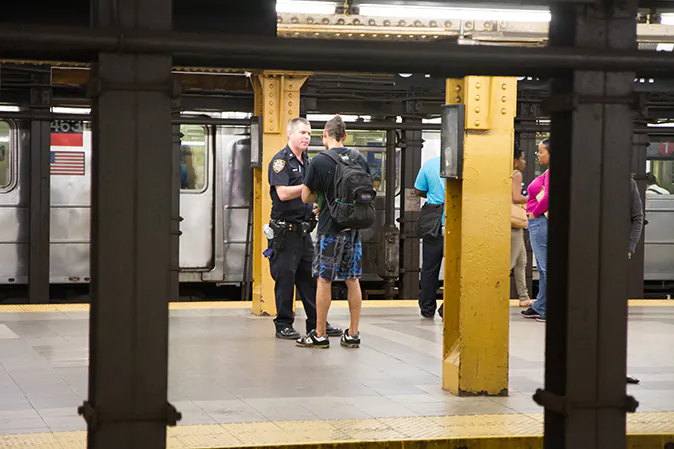 A young man is stopped by a New York police officer at the 34th Penn station subway station in Manhattan on Aug. 7, 2012. Recently, the chief medical examiner's office ruled a homicide in the case of a man who caused a disturbance while high on PCP and died after police restrained him and transported him to a hospital. (Benjamin Chasteen/The Epoch Times)