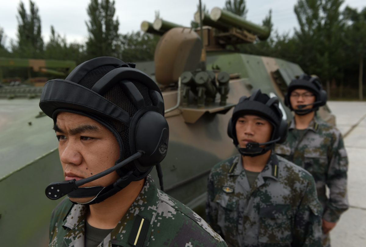 Chinese People's Liberation Army cadets wait beside a T-89 Anti-tank Missile Launcher at the PLA's Armoured Forces Engineering Academy in Beijing on July 22. Xi Jinping, head of the Chiense Communist Party, is calling for a new focus on information warfare. (GREG BAKER/AFP/Getty Images)