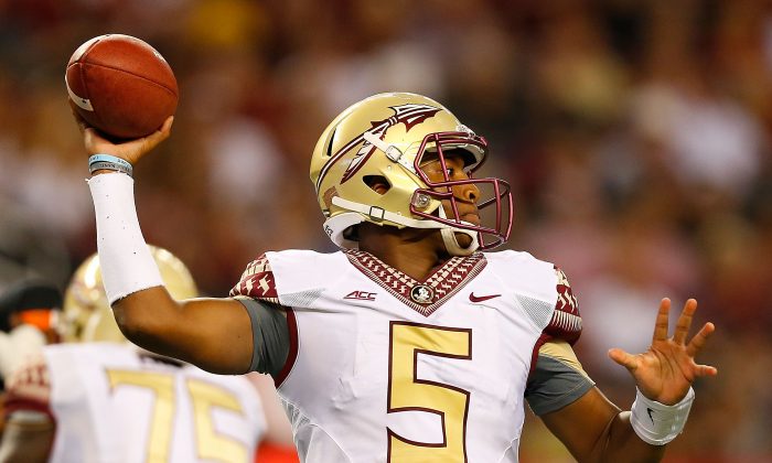Jameis Winston of the Florida State Seminoles threw for 370 yards, but was picked twice in the win over Oklahoma State. (Tom Pennington/Getty Images) 