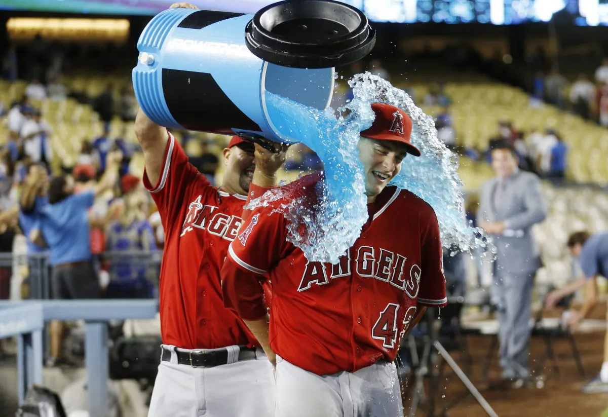 Los Angeles Angels' Albert Pujols, left, pours liquid over starting pitcher Garrett Richards in celebration after Richards pitched a complete game shutout win in a baseball game against the Los Angeles Dodgers, Monday, Aug. 4, 2014, in Los Angeles. The Angels won 5-0. (AP Photo/Danny Moloshok)
