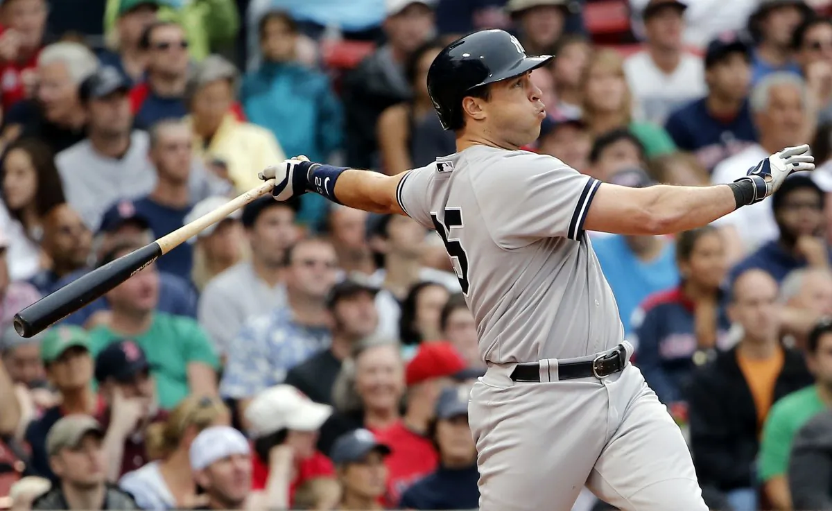 New York Yankees' Mark Teixeira follows through on a solo home run against the Boston Red Sox during the fifth inning of a baseball game at Fenway Park in Boston on Aug. 2, 2014. (Winslow Townson/AP)