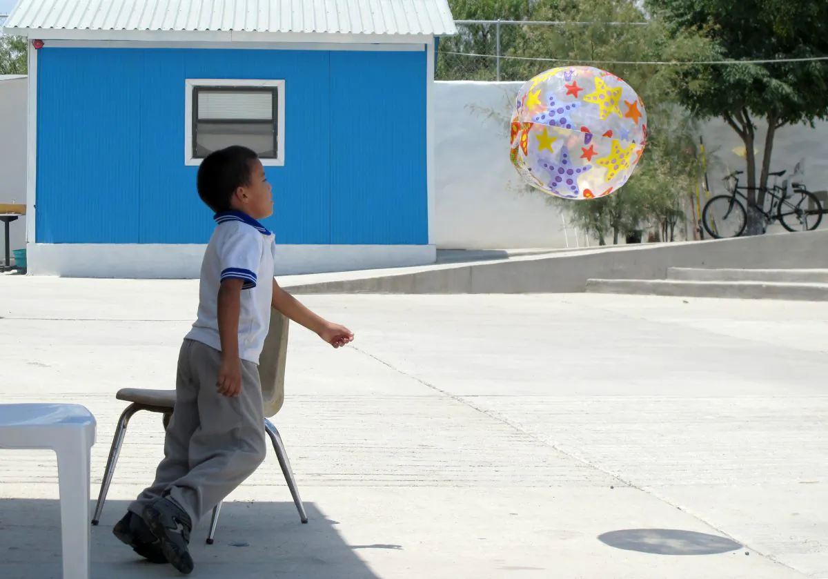 Antony Alvarez, 6, of Honduras plays at the Senda de Vida migrant shelter in Reynosa, Mexico, on Aug. 4, 2014. Alvarez, along with his mother and grandmother, hope to join the thousands of families who have crossed the Rio Grande into the United States. (AP Photo/Christopher Sherman)
