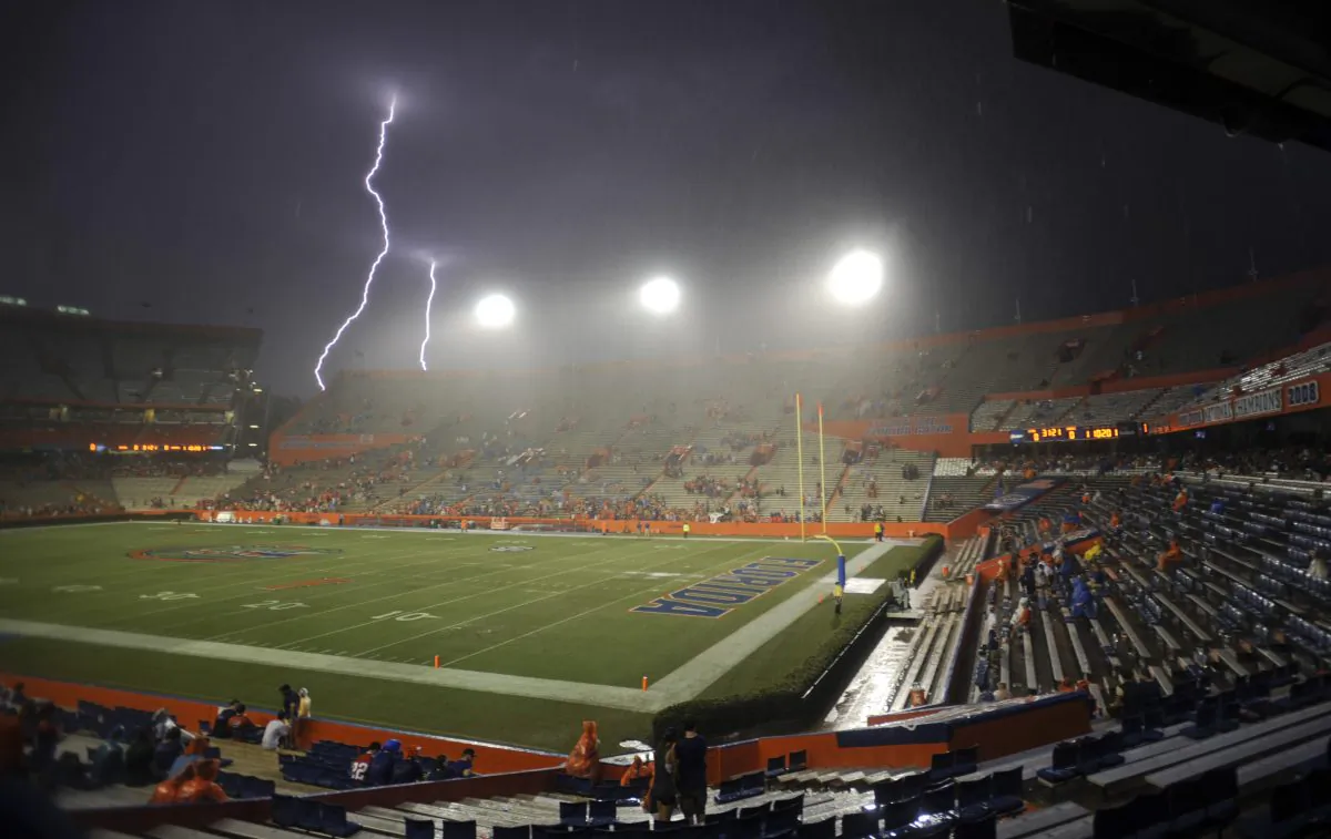 Lightning strikes near Ben Hill Griffin Stadium at Florida Field during a weather delay before an NCAA college football game between Florida and Idaho in Gainesville, Fla., on Aug. 30, 2014. (AP Photo/Phil Sandlin)