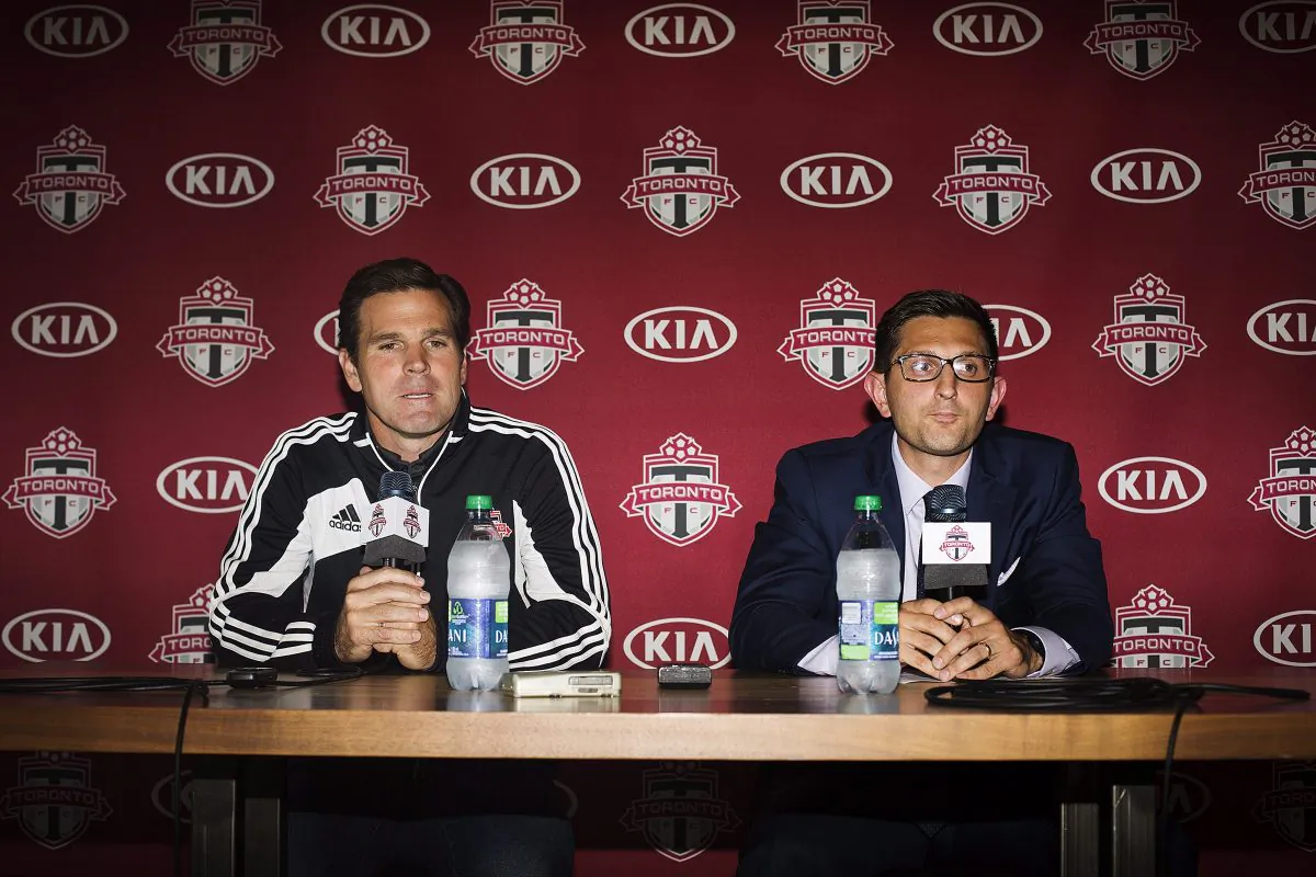 Toronto FC general manager Tim Bezbatchenko (R) names Greg Vanney (L) as head coach of the club replacing Ryan Nelsen during a press conference in Toronto on Aug. 31, 2014. (The Canadian Press/Michelle Siu)