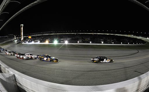 Nationwide Series driver Kasey Kahne (5) leads pole winner Chase Elliott (9) and a pack of cars past Turn One on a restart during the NASCAR Nationwide Cup Series Great Clips 300 auto race at Atlanta Motor Speedway, Saturday, Aug. 30, 2014 in Hampton, Ga. (AP Photo/David Tulis)
