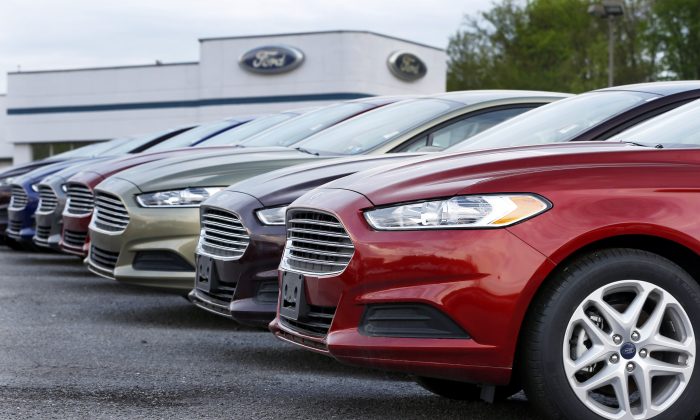 In this May 8, 2013, photo, a row of new 2013 Ford Fusions are on display at an automobile dealership in Zelienople, Pa. As the auto industry strives to sustain its post-recession comeback, car companies are resorting to tactics that some experts warn will lead to trouble down the road. (AP Photo/Keith Srakocic)