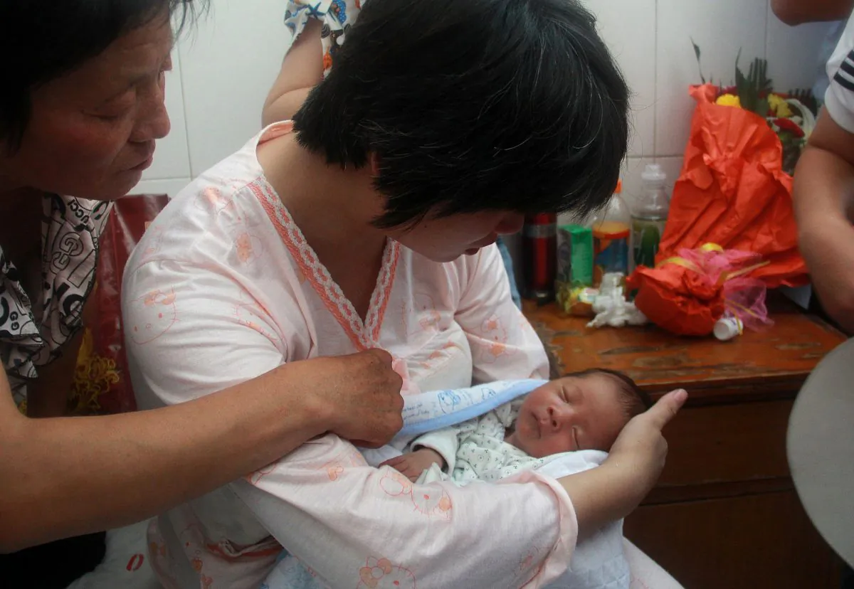A woman reunites with her newborn baby who was sold by the doctor who delivered him at a hospital in Fuping County, central China's Shanxi province on Aug. 5, 2013. Other cases have been reported across China in recent years. (STR/AFP/Getty Images)