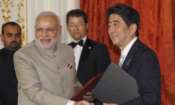 Indian Prime Minister Narendra Modi (L) shakes hands with Japanese Prime Minister Shinzo Abe during a signing ceremony in Tokyo on September 1, 2014. Modi's trip to Japan follows the new government's foreign policy direction of "Acting East" versus "Looking East". (Shizuo Kambayashi/AFP/Getty Images)