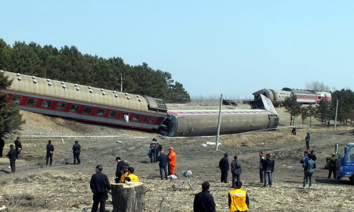 Rescuers work at the site where a train derailed on April 13, 2014, in the Hailun country of Suihua City, Heilongjiang province of China. (ChinaFotoPress/Getty Images)