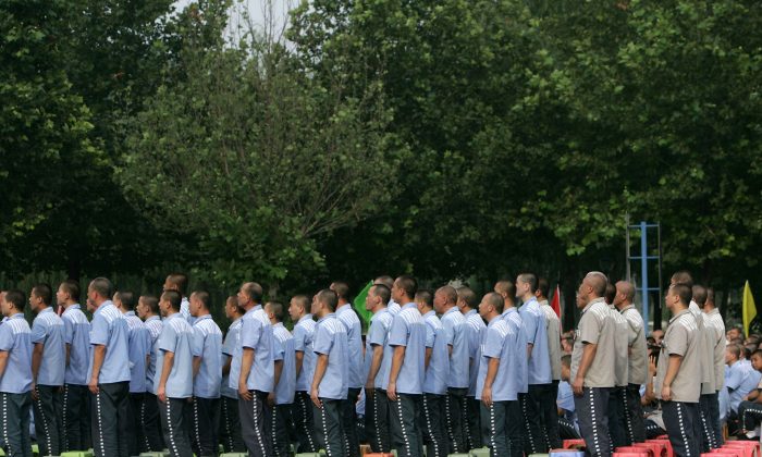 Inmates stand at the Tianhe Prison on Aug. 8, 2007 in Beijing, China. The recent reversal of two death penalty cases in Fujian Province doesn't mark any change in the legal system in China, argues Heng He. (China Photos/Getty Images) 