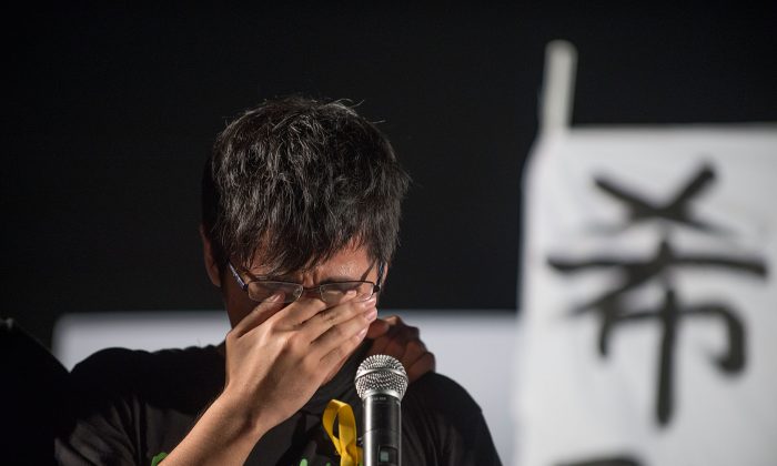 Hong Kong Federation of Students Chairperson Yong Kang Alex Chow cries as he gives a speech during the protest at Tamar Park outside of the Hong Kong Government Building on Aug. 31, 2014. (Anthony Kwan/Getty Images)